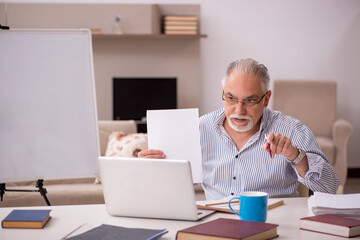 Fototapeta premium Old male employee working from home during pandemic