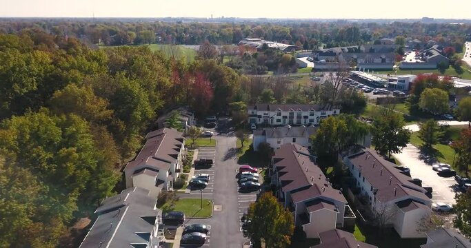 Tree lined neighborhood of town homes condos. Renters and buyers alike reside. Aslo called Townhouses. Shot flying forward in 4k.