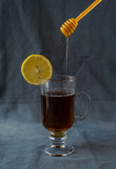 cup of tea with lemon. Lemon slices are falling in the background.