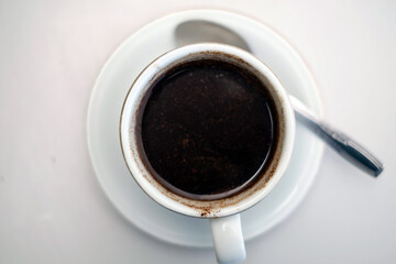 Obraz na płótnie Canvas cup of black coffee on a white table