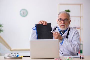 Old male doctor pharmacist working at the lab