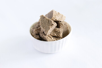 halva from sunflower seeds on a white plate. national traditional sweetness of turkish halva on the table. High quality photo