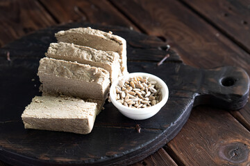 Sunflower halva with seeds on a dark background. Made from sunflower seeds. High quality photo