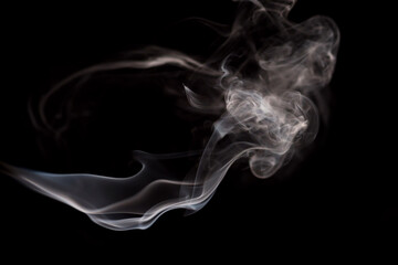 Abstract movement of smoke on dark background. Concept of alternative non-nicotine smoking. Blurry image warm toned vape smoke. Electronic Cigarette. Evaporator. Soft focus. Streaming.