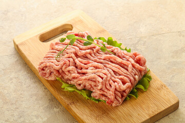 Raw minced pork meat over board