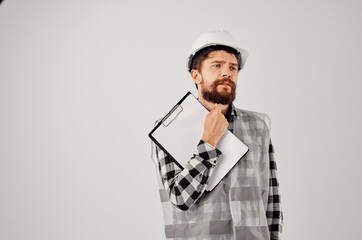 male builder in a white helmet blueprints Professional studio industry