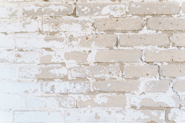 Brick wall texture with faded white paint.