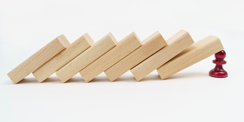 The red pawn is holding back the fallen wooden planks.