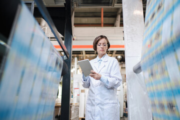 Female worker using tablet at the factory