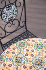 Textured table and chair with bright ornaments.