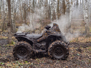 
a dirty and wet atv from which steam is coming