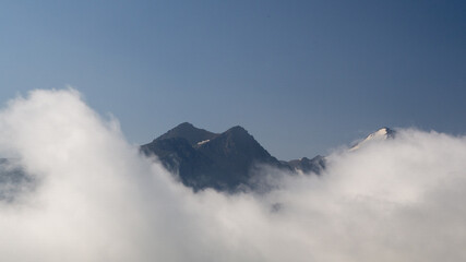 a mountain peak among the clouds