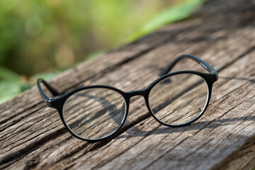 glasses and the diary (wrote the word Tee Lau Zu on it) put on the wooden bench in relaxing time.