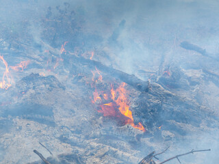 a fire of twigs and smoke