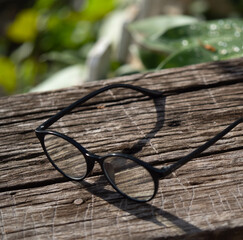 glasses and the diary (wrote the word Tee Lau Zu on it) put on the wooden bench in relaxing time.