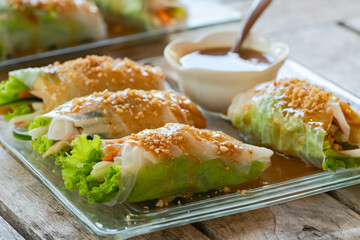 lumpiang ubod is appetizer food made from strips of palm heart lettuce, sauteed with shrimp and pork, rolled in rice wrapper and served with homemade peanut sauce