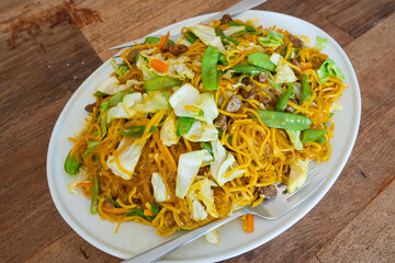 mixed egg noodles and rice noodle stir fried with shrimp, vegetables and pork liver also known as panci 