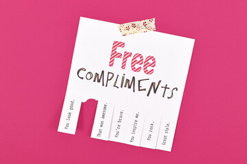 Tear off note with motivational free compliments on pink background - obrazy, fototapety, plakaty