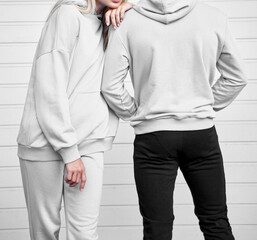 Close up of hoodie on a girl. Pair of woman and man are standing in hooded jumper. Branding and...