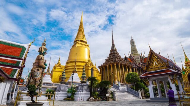 4K Timelapse of Wat Phra Si Rattana Satsadaram (Wat Phra Kaew) or Temple of the Emerald buddha over blue sky and white cloud. Most popular temple of tourist in Bangkok, Thailand