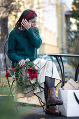 Stylish young woman on a walk after shopping, Christmas preparations.