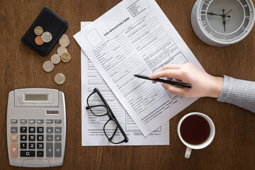 Visa application form on a wooden table, visa processing, registration, flat lay