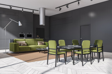Corner of living space with grey kitchen and green furniture