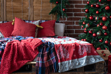 Christmas bedroom interior with red-green colors with a Christmas tree.