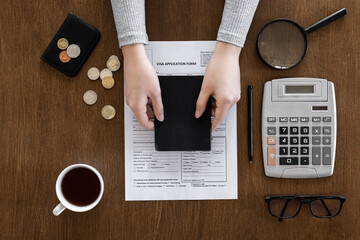 Visa application form on a wooden table, visa processing, registration, flat lay