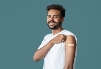 Man smiling after receiving vaccination, young men received corona vaccine studio portrait
