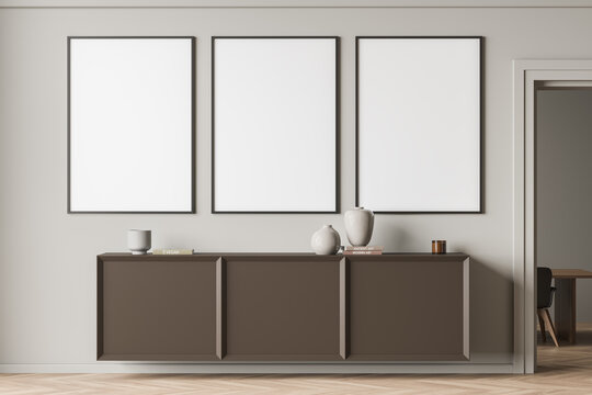 Bright gallery room interior with three empty white posters