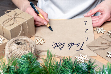 Writing a to-do list, Wish list for new year christmas - a hand writing with a pen on empty...