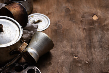 Fototapeta na wymiar Old vintage iron pots and metallic dish