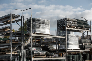 stock of wire netting and iron stakes in a large DIY area
