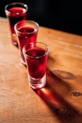 Various alcohol shot drinks on the wooden bar desk