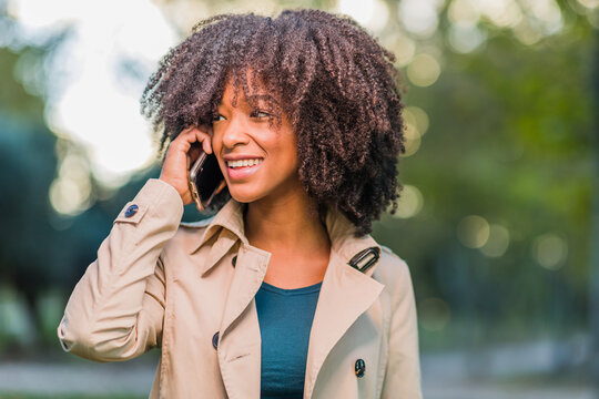Mobile Technology. Latin Dominican Republic woman with afro curly hair portrait