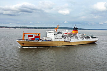 Fototapeta premium Vessels, passenger ships and tugboats in port under cargo operations and underway. Port of Surabaya, Indonesia, January,2021