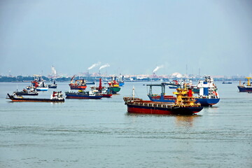 Vessels, passenger ships and tugboats in port under cargo operations and underway. Port of...