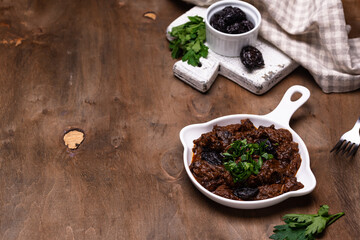 Hot stewed meat with prunes