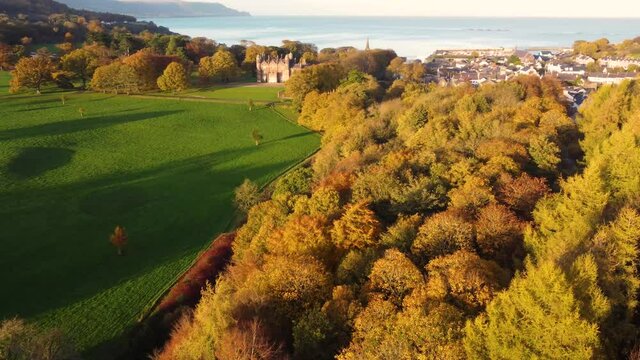 Aerial footage of Glenarm Castle and Forest in Autumn Sunset Ireland 