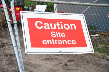 Construction site health and safety message rules sign board signage on fence boundary