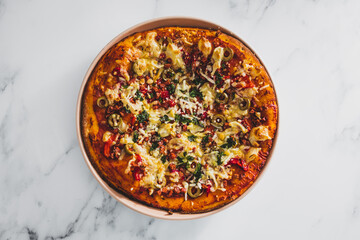 vegan pizza with red pepper olives plant-based bacon bits and dairy-freee cheese, healthy plant-based food