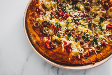 vegan pizza with red pepper olives plant-based bacon bits and dairy-freee cheese, healthy plant-based food