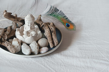 Buddha and minerals, natural decor on plate, abstract background. Magic gemstones crystals for healing esoteric spiritual practice, relaxation and meditation. life balance, spa concept