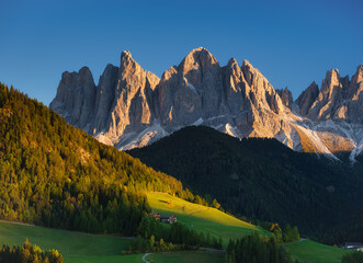 Santa Maddalena. Val di Funes. Dolomite Alps. Italy. The mountains and the forest before sunset....