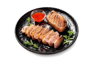 Roasted duck breast served with sauce and fresh herbs. Isolated on white background	