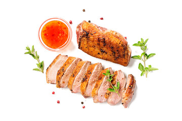 Roasted duck breast served with sauce and fresh herbs. Isolated on white background	