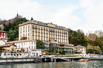 Fototapeta na wymiar Grand Hotel on the shore of the town of Tremezzo with a yacht pier. Lake Como, Italy