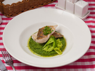 pike perch fillet on a spinach pillow in a restaurant