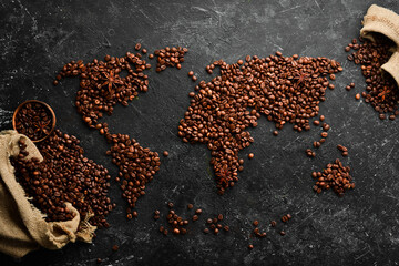 Aromatic coffee beans. Set of coffee beans in the shape of a world map. Top view. On a dark background.